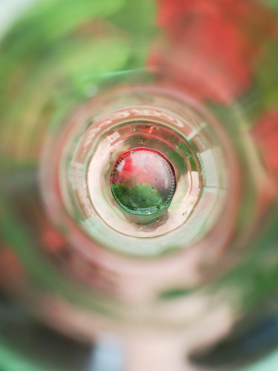 Photo assignment: Find something that represents colors on the rainbow for a photo series.Photo: Through the lens of a glass cola bottle, red by Katy Chumbley.
